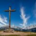 Cross in the mountains, sky with clouds in the backgroun